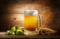 Mug of beer with green hops and wheat ears Royalty Free Stock Photo