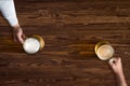 Mug of beer in hand on background of the wooden texture Royalty Free Stock Photo