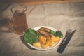 Mug of beer with plate of grilled sausages Royalty Free Stock Photo