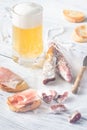 Mug of beer with sandwiches and smoked sausage Royalty Free Stock Photo