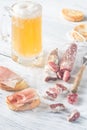 Mug of beer with sandwiches and smoked sausage Royalty Free Stock Photo