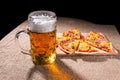 Mug of Beer and Slices of Pizza on Cutting Board Royalty Free Stock Photo