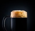 Mug of black beer or kvass on a black background. Foam close-up. Stock photo Royalty Free Stock Photo