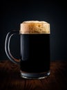 Mug of black beer or kvass on a black background. Stock photo Royalty Free Stock Photo