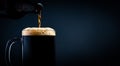 A mug of black beer pouring from a bottle close-up, on a dark background. Stock photo Royalty Free Stock Photo