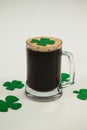 Mug of black beer and shamrock for St Patricks Day Royalty Free Stock Photo