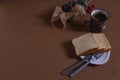 Mug of black coffee, bread slices and decorations with pine cones on a brown table Royalty Free Stock Photo