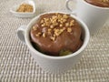 Mug Cake with chocolate icing and almond brittle