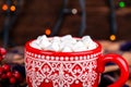 Mug with cocoa and marshmallows with cozy Christmas garland lights background Royalty Free Stock Photo