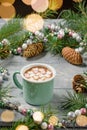 A mug of cocoa with marshmallows on a table with Christmas decor Royalty Free Stock Photo