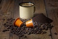 Mug of coffee with coffee beans, pods and ground coffee Royalty Free Stock Photo