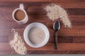 Mug of Coffee & bowl of porridge on a dark wooden worktop