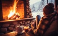 mug of coffee by the Christmas fireplace. Woman relaxes by warm fire with a cup of hot drink. Winter, Christmas holidays