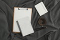 Mug of coffee with clipboard, diary and pen on gray. Flat lay, top view. Stay at home concept