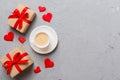 Mug coffee and gift box on colored background. Flat lay composition. Holiday concept