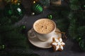 Mug of Coffee Latte and Christmas Gingerbread cookie into Pine Decor Royalty Free Stock Photo
