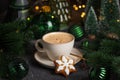 Mug of Coffee Latte and Christmas Gingerbread cookie into Pine Decor Royalty Free Stock Photo