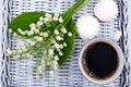 A mug of coffee, marshmallows and flowers lie on a blue table