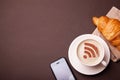 Mug of coffee with WiFi sign on the foam. Free access point to the Internet WiFi. I like coffee break with croissant Royalty Free Stock Photo