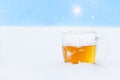 Mug of cold beer on the snow