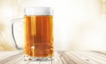 Mug of cold beer on wooden table Royalty Free Stock Photo