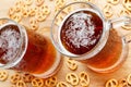 Mug of cold foamy beer with german brezel