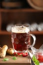 Mug of delicious beer with grilled sausages and chili peppers on wooden board Royalty Free Stock Photo