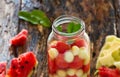 Mug delicious refreshing drink of mix fruits watermelon and cantaloupe, infusion water Royalty Free Stock Photo