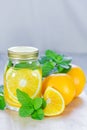 Mug delicious refreshing drink of orange fruit with mint Royalty Free Stock Photo