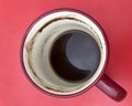 mug of drunk coffee with grounds on the bottom on a pink background Royalty Free Stock Photo