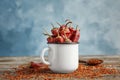 Mug with dry chili peppers and powder Royalty Free Stock Photo