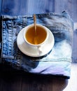 Mug filled boiling water and tea bag on blue jeans background. Process tea brewing in ceramic mug. Herbal green or black Royalty Free Stock Photo