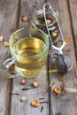 Mug of flavored green tea with rose buds and petals Royalty Free Stock Photo