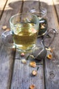 Mug of flavored green tea with rose buds and petals Royalty Free Stock Photo