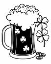 A mug of frothy beer is adorned with clovers, symbolizing a festive or Irish theme Royalty Free Stock Photo