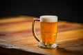 Mug full of chopp, with chopp pilsen on a rustic table Royalty Free Stock Photo