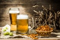 Mug, glass of beer on wooden table Royalty Free Stock Photo