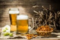 Mug, glass of foamy beer on empty wooden background Royalty Free Stock Photo