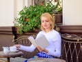 Mug of good coffee and pleasant book best combination for perfect weekend. Girl drink coffee every morning at same place Royalty Free Stock Photo