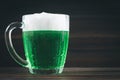 A mug of green beer on the table. Clover leaves. Chest of gold, coins pile. St.Patrick's Day. Royalty Free Stock Photo