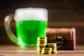 A mug of green beer on the table. Clover leaves. Chest of gold, coins pile. St.Patrick's Day.