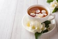 Mug of herbal tea with petals of Jasmine flowers on a light background Royalty Free Stock Photo