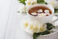 Mug of herbal tea with petals of Jasmine flowers on a light background. Copy space Royalty Free Stock Photo