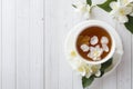 Mug of herbal tea with petals of Jasmine flowers on a light background. Copy space Royalty Free Stock Photo