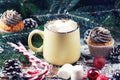 Mug with hot chocolate and cup cake snow wooden table Royalty Free Stock Photo