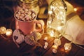 Mug with hot chocolate, marshmallows and lights Royalty Free Stock Photo