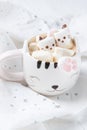 Mug with hot chocolate and melted marshmallows in the shape of cats, kittens Royalty Free Stock Photo