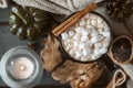 Mug of hot coffee, chocolate with lots of marshmallows , cinnamon, small green pumpkin, candle , dry autumn leaves,  cone, close Royalty Free Stock Photo