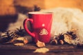 Mug of hot coffee in a woman's hand in a sweater in the autumn setting on a wooden table with a knitted scarf, sweater. Comfort, Royalty Free Stock Photo