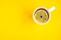 Mug of hot tea with lemon on yellow background. Catarrhal disease. Flu season